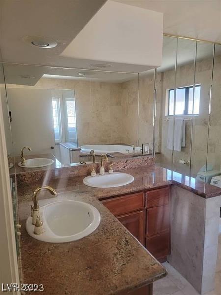 3480 E Hacienda Ave, Las Vegas, NV 89120 - bathroom featuring double vanity, a bath, and plenty of natural light