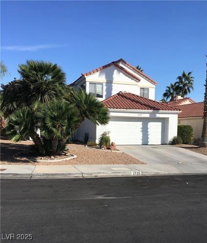 2720 Knightsbridge Rd, Henderson, NV 89074 - mediterranean / spanish home with a tile roof, driveway, an attached garage, and stucco siding