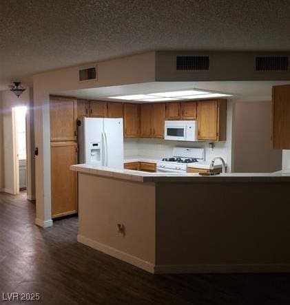 2720 Knightsbridge Rd, Henderson, NV 89074 - kitchen with white appliances, dark wood-style floors, brown cabinets, baseboards, and a textured ceiling