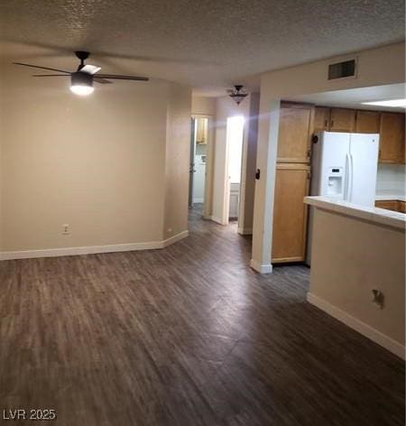 2720 Knightsbridge Rd, Henderson, NV 89074 - unfurnished living room featuring dark wood finished floors, baseboards, a textured ceiling, and ceiling fan