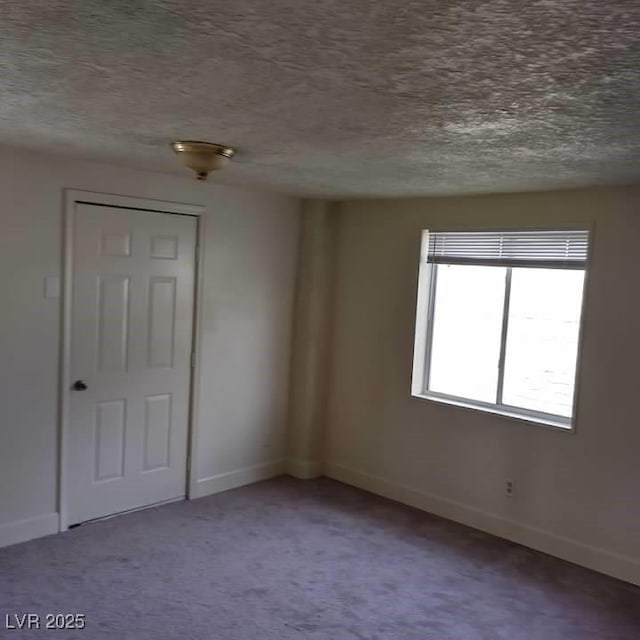 1413 Bryn Mawr Ave, Las Vegas, NV 89102 - carpeted empty room with a textured ceiling and baseboards