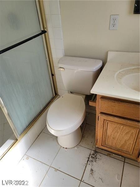1413 Bryn Mawr Ave, Las Vegas, NV 89102 - bathroom with vanity, a stall shower, toilet, and tile patterned flooring