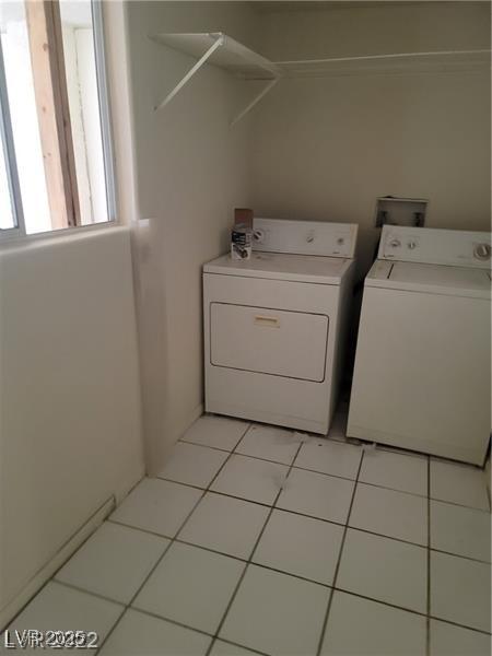 1413 Bryn Mawr Ave, Las Vegas, NV 89102 - laundry room with separate washer and dryer and light tile patterned floors