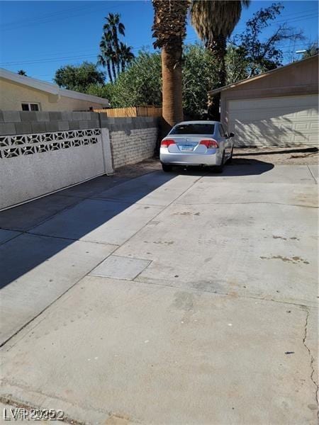 1413 Bryn Mawr Ave, Las Vegas, NV 89102 - view of vehicle parking with driveway and a garage