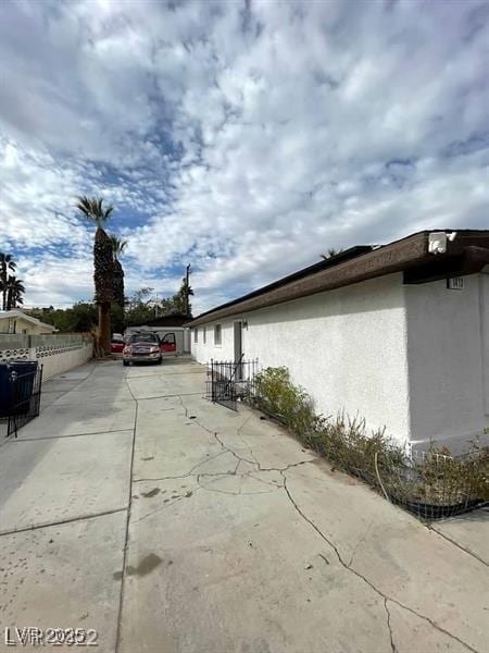 1413 Bryn Mawr Ave, Las Vegas, NV 89102 - view of side of property with stucco siding and a patio