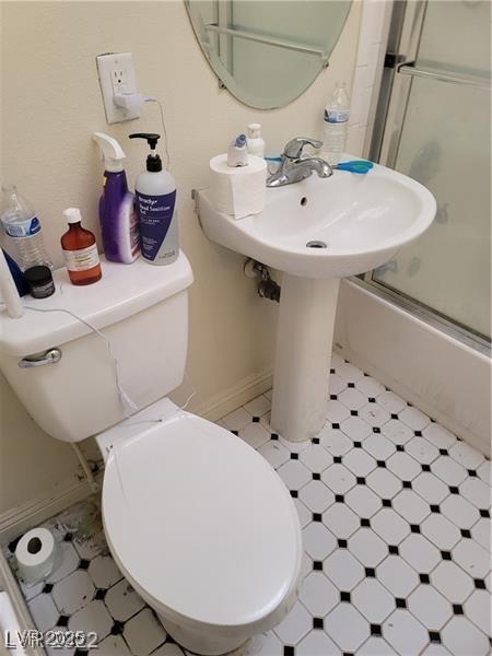 1413 Bryn Mawr Ave, Las Vegas, NV 89102 - bathroom with toilet, combined bath / shower with glass door, and tile patterned floors