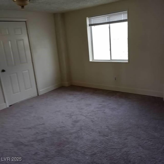 1413 Bryn Mawr Ave, Las Vegas, NV 89102 - carpeted spare room with baseboards and a textured ceiling
