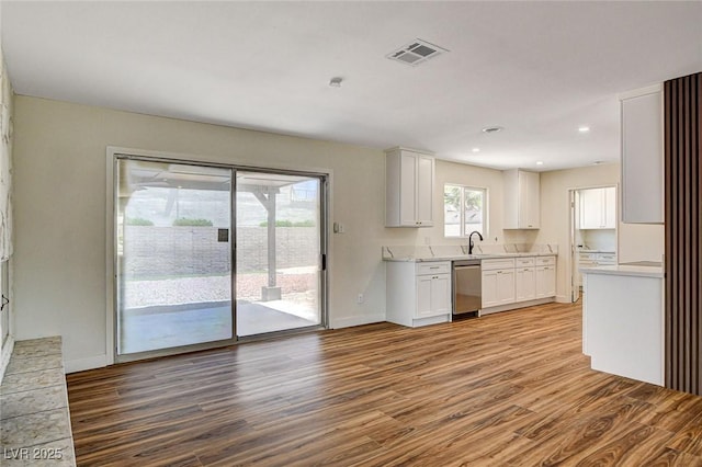 3386 El Camino Real, Las Vegas, NV 89121 - kitchen with stainless steel dishwasher, wood finished floors, light countertops, white cabinetry, and recessed lighting