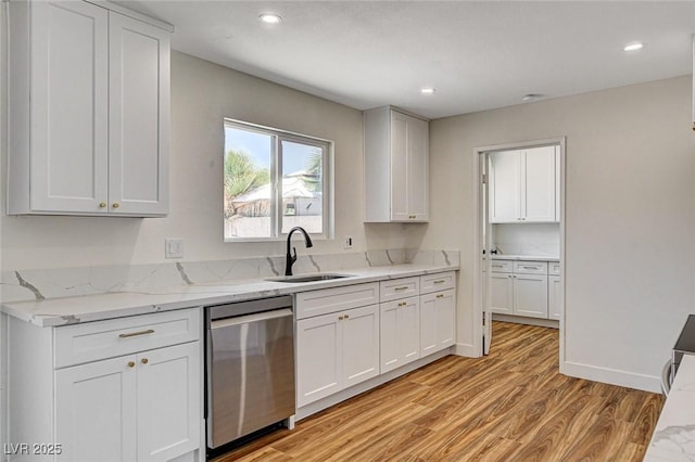3386 El Camino Real, Las Vegas, NV 89121 - kitchen with stainless steel dishwasher, a sink, light wood-style floors, light stone countertops, and recessed lighting