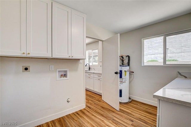 3386 El Camino Real, Las Vegas, NV 89121 - laundry room featuring water heater, hookup for an electric dryer, baseboards, light wood-style floors, and washer hookup