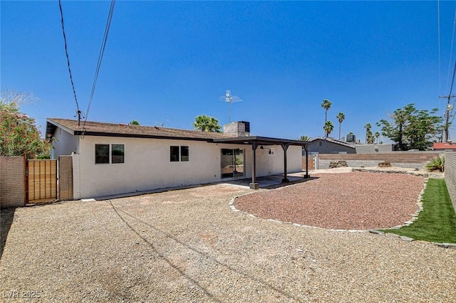 3386 El Camino Real, Las Vegas, NV 89121 - back of house with a fenced backyard, a patio, stucco siding, and a chimney