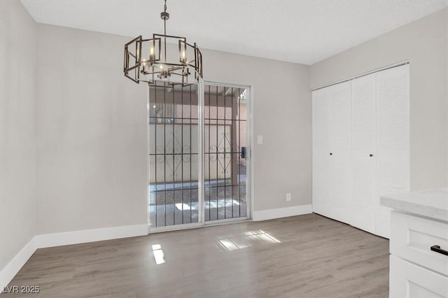 417 N Lamb Blvd Unit E, Las Vegas, NV 89110 - unfurnished dining area with a chandelier, baseboards, and wood finished floors