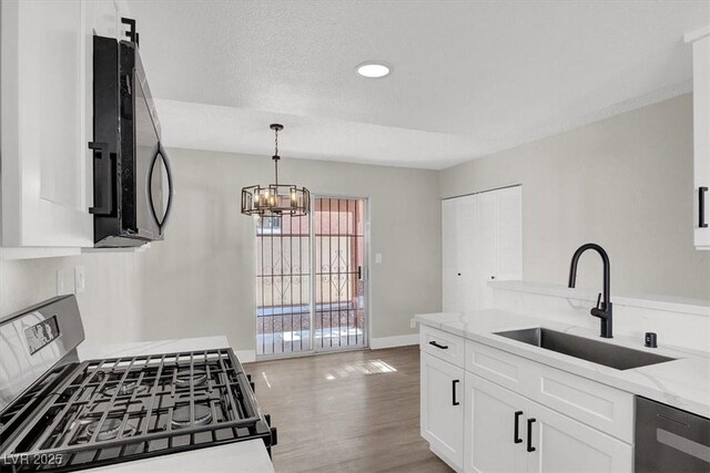 417 N Lamb Blvd Unit E, Las Vegas, NV 89110 - kitchen featuring stainless steel range with gas stovetop, a sink, dishwashing machine, light stone countertops, and recessed lighting