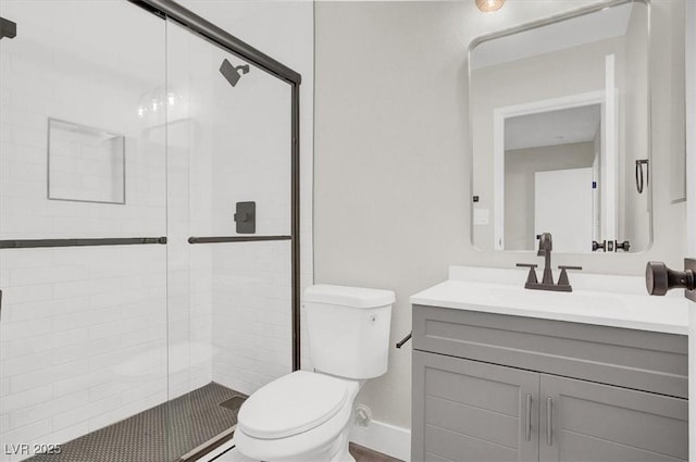 417 N Lamb Blvd Unit E, Las Vegas, NV 89110 - bathroom featuring toilet, a stall shower, vanity, and baseboards