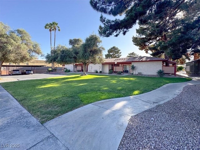 417 N Lamb Blvd Unit E, Las Vegas, NV 89110 - view of front facade with a front lawn and stucco siding