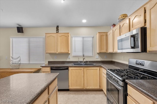 5937 Round Castle St, Las Vegas, NV 89130 - kitchen featuring appliances with stainless steel finishes, light brown cabinetry, a sink, dark countertops, and recessed lighting