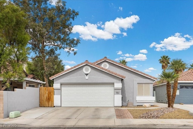 5937 Round Castle St, Las Vegas, NV 89130 - ranch-style home with concrete driveway, stucco siding, a tiled roof, and an attached garage
