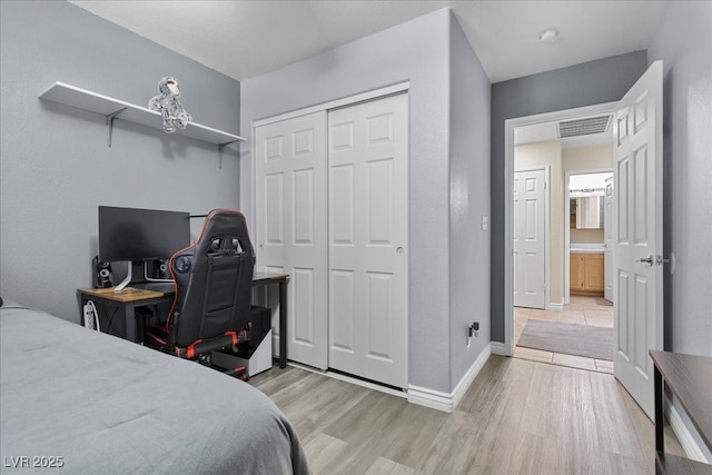 5937 Round Castle St, Las Vegas, NV 89130 - bedroom featuring light wood-style flooring, a closet, baseboards, and an office area