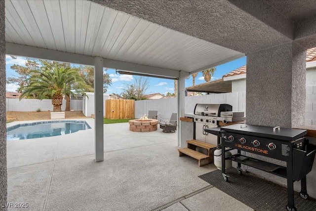 5937 Round Castle St, Las Vegas, NV 89130 - fenced backyard with an outdoor fire pit, a patio area, and a grill