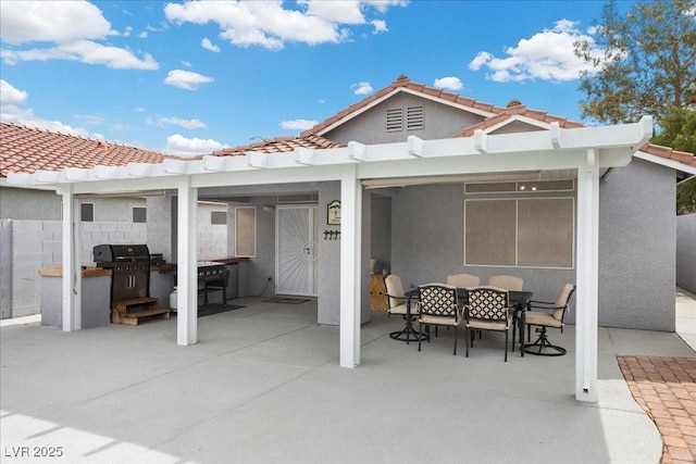 5937 Round Castle St, Las Vegas, NV 89130 - rear view of house featuring stucco siding, a patio area, outdoor dining area, and a tile roof