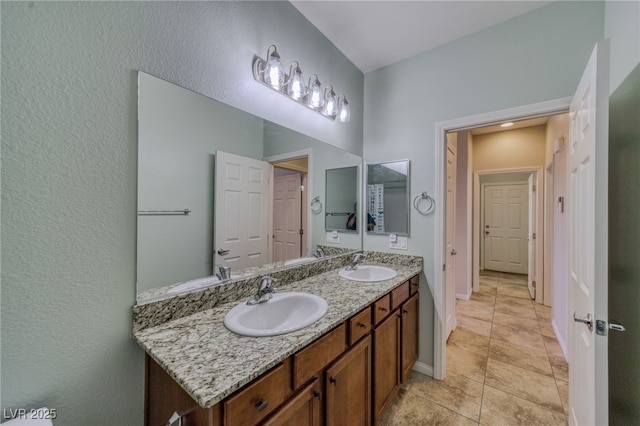 2099 Port Royal Dr, Laughlin, NV 89029 - bathroom featuring double vanity, baseboards, and a textured wall