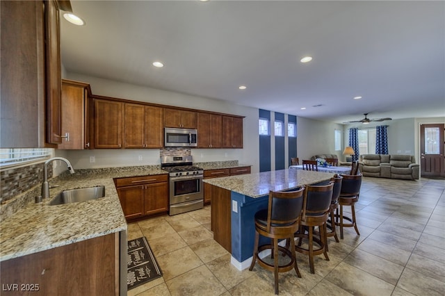 2099 Port Royal Dr, Laughlin, NV 89029 - kitchen with stainless steel appliances, a sink, healthy amount of natural light, a center island, and recessed lighting