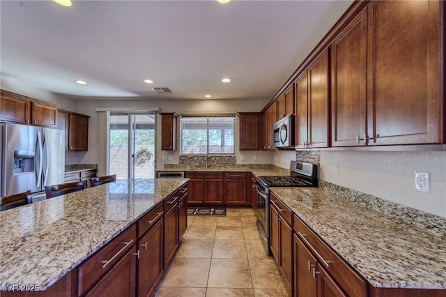 2099 Port Royal Dr, Laughlin, NV 89029 - kitchen with appliances with stainless steel finishes, a sink, a center island, light stone countertops, and recessed lighting