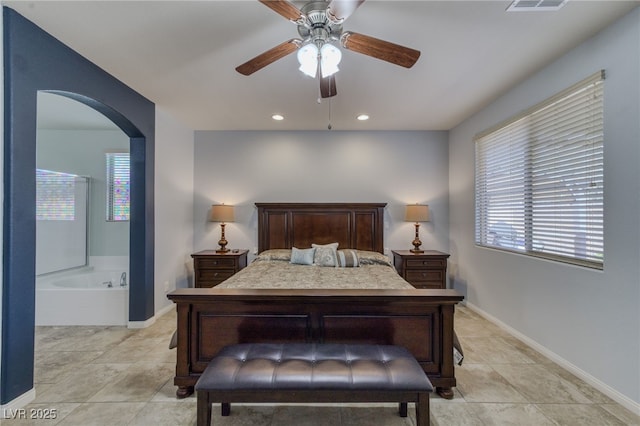 2099 Port Royal Dr, Laughlin, NV 89029 - bedroom with arched walkways, multiple windows, baseboards, light tile patterned floors, and recessed lighting
