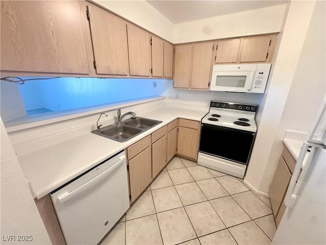 2064 Mesquite Ln Unit 102, Laughlin, NV 89029 - kitchen featuring white appliances, a sink, light countertops, light tile patterned floors, and light brown cabinetry