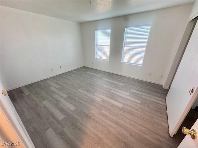 2064 Mesquite Ln Unit 102, Laughlin, NV 89029 - spare room featuring wood finished floors and baseboards