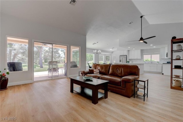 3040 Hidden Treasure Dr, Las Vegas, NV 89134 - living room featuring light wood-type flooring, ceiling fan, lofted ceiling, baseboards, and a chandelier