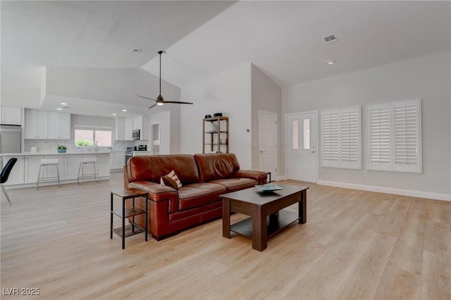 3040 Hidden Treasure Dr, Las Vegas, NV 89134 - living room featuring light wood finished floors, a ceiling fan, recessed lighting, high vaulted ceiling, and baseboards
