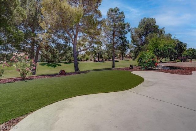 3040 Hidden Treasure Dr, Las Vegas, NV 89134 - view of property's community featuring a lawn and a patio area