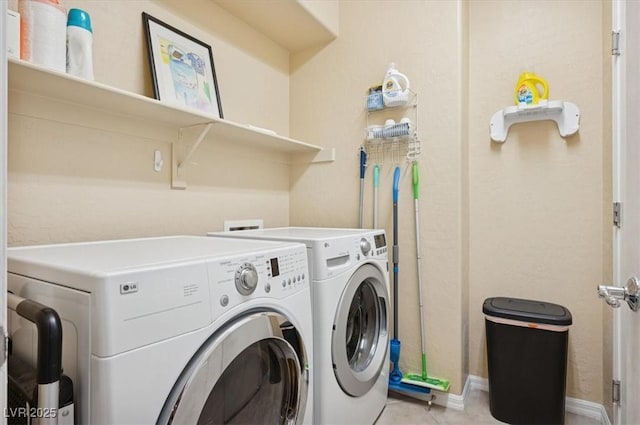 2453 Vivid Sky Pl, Henderson, NV 89044 - laundry area with washing machine and clothes dryer, baseboards, and light tile patterned floors