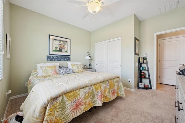 2453 Vivid Sky Pl, Henderson, NV 89044 - bedroom featuring light carpet, a closet, baseboards, and ceiling fan