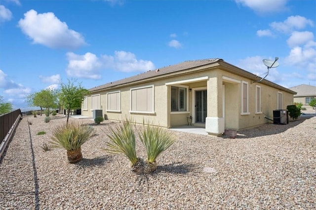 2453 Vivid Sky Pl, Henderson, NV 89044 - back of property with central AC unit, stucco siding, and a patio