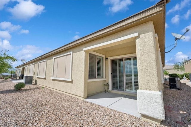2453 Vivid Sky Pl, Henderson, NV 89044 - view of home's exterior with cooling unit, a patio area, and stucco siding