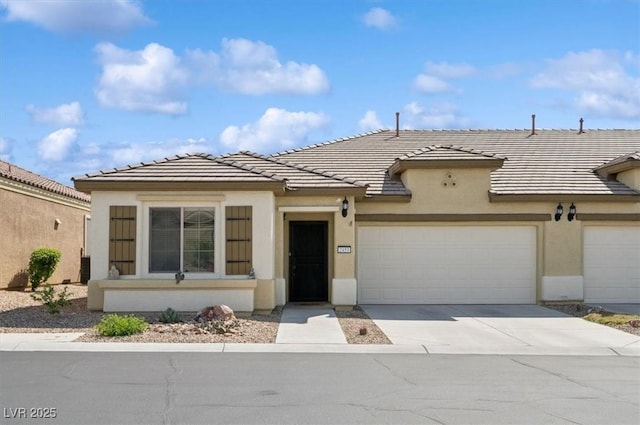 2453 Vivid Sky Pl, Henderson, NV 89044 - view of front of home with stucco siding, a garage, driveway, and a tile roof