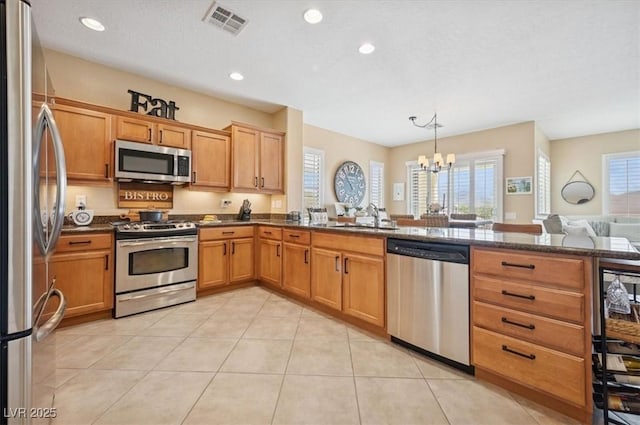 2453 Vivid Sky Pl, Henderson, NV 89044 - kitchen featuring appliances with stainless steel finishes, a sink, a chandelier, light tile patterned floors, and recessed lighting