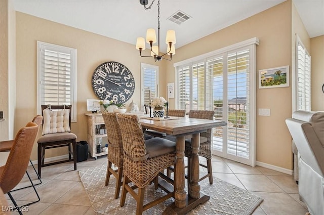 2453 Vivid Sky Pl, Henderson, NV 89044 - dining area featuring a chandelier, healthy amount of natural light, light tile patterned floors, and baseboards