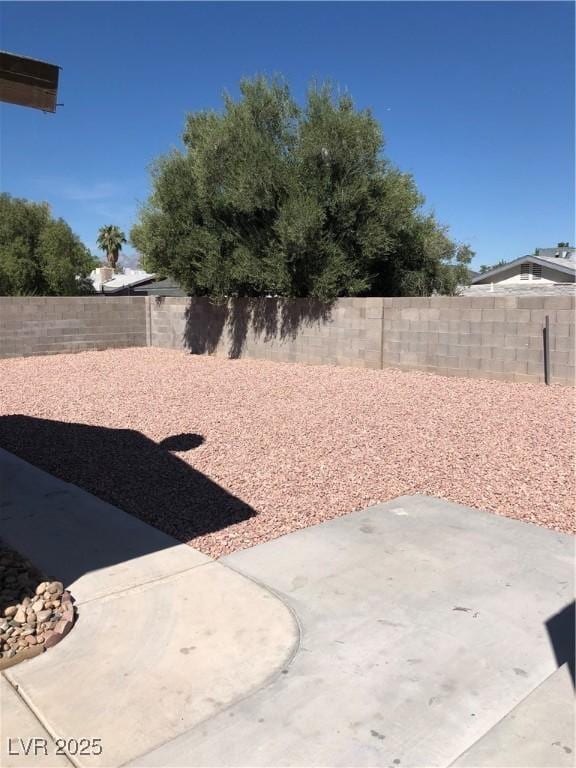 6196 W University Ave, Las Vegas, NV 89103 - fenced backyard featuring a patio
