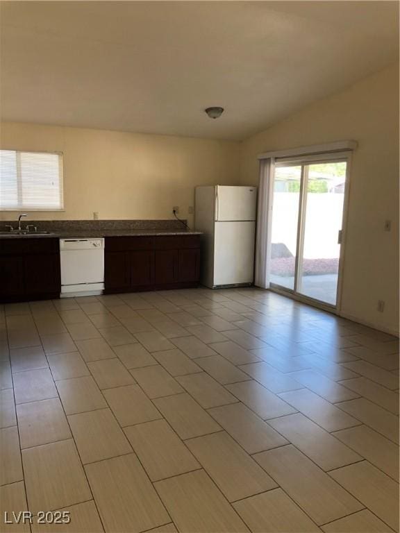 6196 W University Ave, Las Vegas, NV 89103 - kitchen with white appliances, a sink, light tile patterned flooring, and dark brown cabinetry