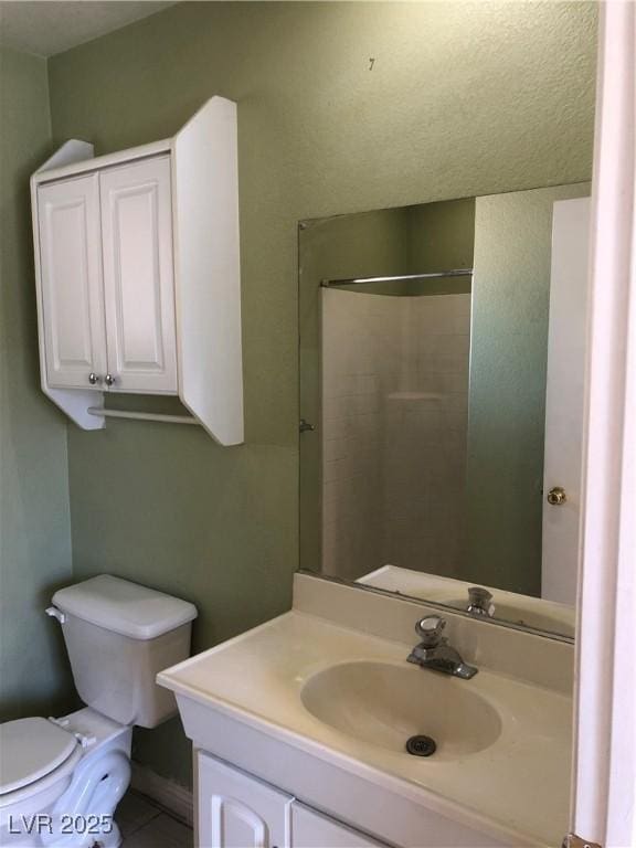 6196 W University Ave, Las Vegas, NV 89103 - full bathroom with toilet, vanity, and tile patterned flooring