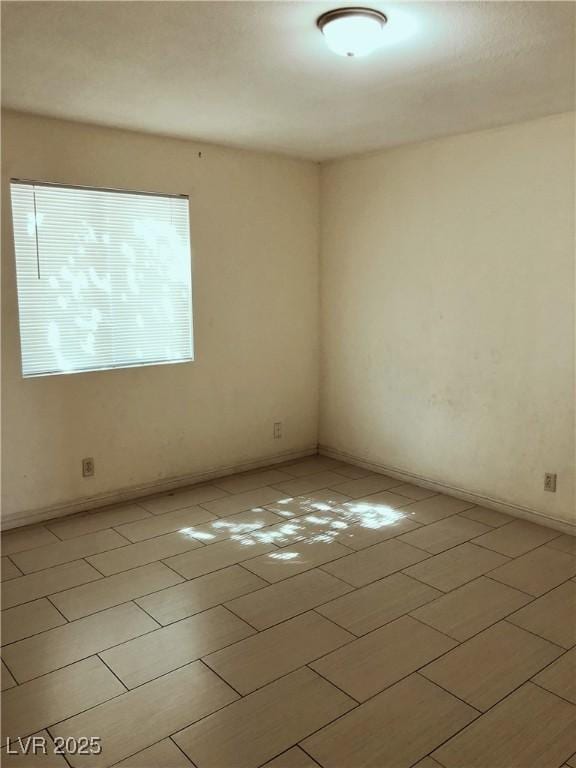 6196 W University Ave, Las Vegas, NV 89103 - unfurnished room featuring light tile patterned flooring and baseboards