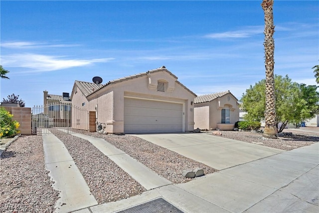 6125 Desert Haven Rd, Las Vegas, NV 89130 - view of front of property with a gate, stucco siding, driveway, an attached garage, and a tiled roof
