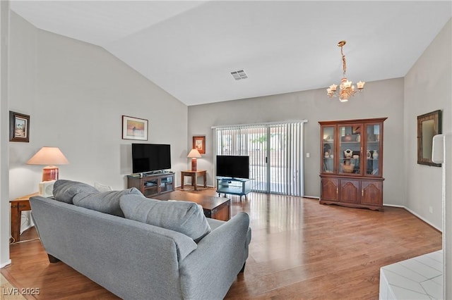 6125 Desert Haven Rd, Las Vegas, NV 89130 - living area featuring a chandelier, wood finished floors, and high vaulted ceiling