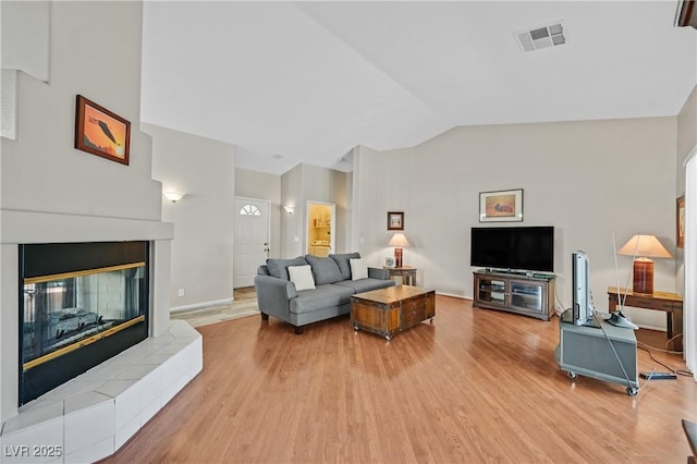 6125 Desert Haven Rd, Las Vegas, NV 89130 - living room with light wood-type flooring, a fireplace, and high vaulted ceiling