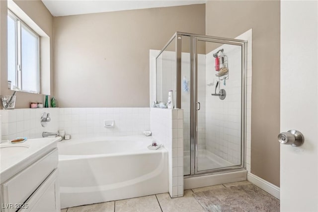 628 Bay Bridge Dr, North Las Vegas, NV 89032 - full bathroom with a garden tub, a shower stall, tile patterned floors, vanity, and baseboards