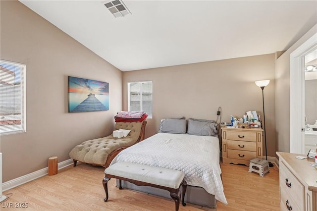 628 Bay Bridge Dr, North Las Vegas, NV 89032 - bedroom with light wood-style flooring, vaulted ceiling, and connected bathroom