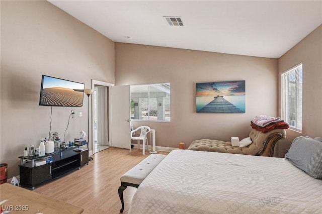 628 Bay Bridge Dr, North Las Vegas, NV 89032 - bedroom with wood finished floors, vaulted ceiling, and baseboards